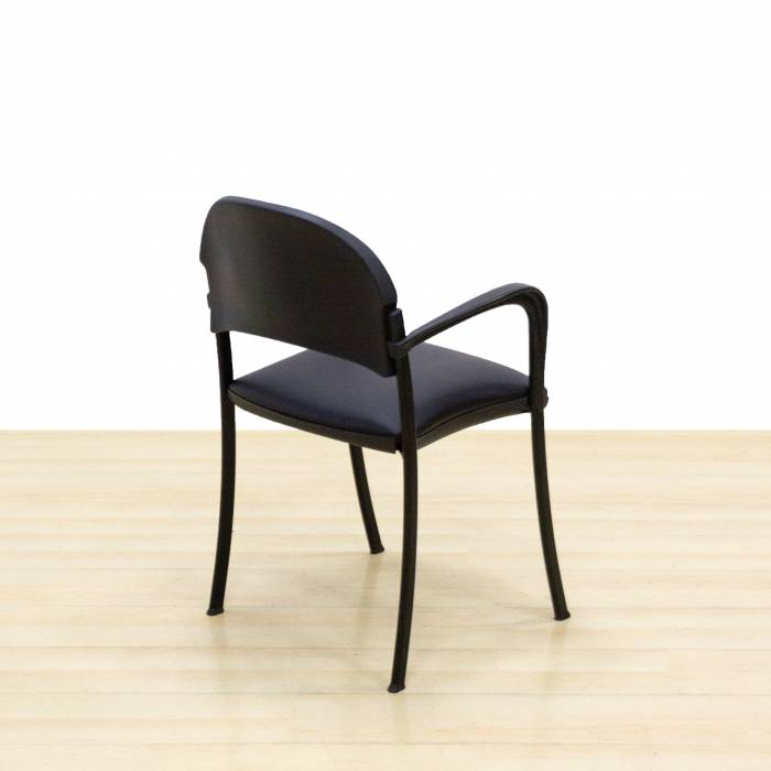 Confidant chair Mod. CLADE. Upholstered in black leatherette. Metallic structure.