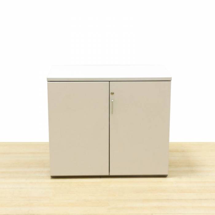 Low cabinet ACTIU Mod. CORDU. Made of white and gray wood. Folding doors.