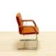 Confidant chair DYNAMOBEL Mod. DARIO. Upholstered in orange imitation leather. Skate base.