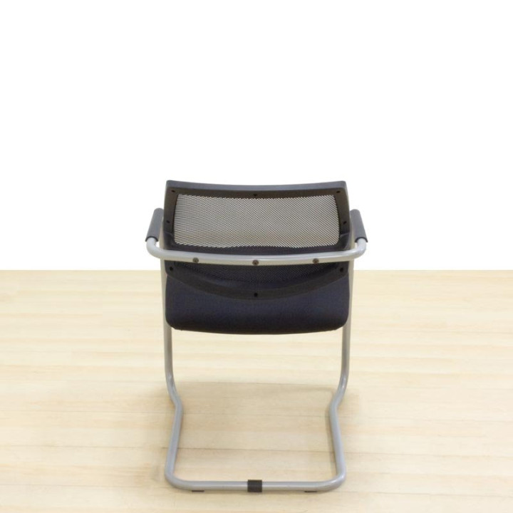 Confidant chair Mod. NERIO. Upholstered in black fabric. Skate base.